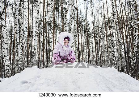 A young girl playing in the snow View Large Photo Image Stock Image - A young girl playing in the snow. Fotosearch