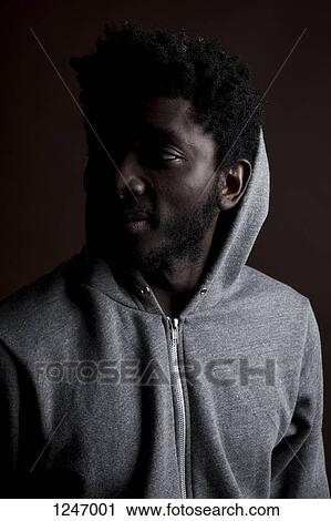 A young hip man looking away, close-up View Large Photo Image Stock Image - A young hip man looking away, close-up. Fotosearch