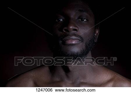 A young man with a labret piercing staring seriously into the camera View Large Photo Image Stock Photograph - A young man with a labret piercing staring seriously into the camera. Fotosearch