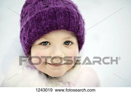 A young smiling girl wearing a knit cap, outdoors in winter View Large Photo Image Stock Photo - A young smiling girl wearing a knit cap, outdoors in winter. Fotosearch