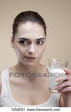 A young woman making a face after taking a drink of milk View Large Photo Image Stock Image - A young woman making a face after taking a drink of milk. Fotosearch