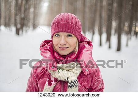 A young woman wearing warm clothing outdoors in winter View Large Photo Image Stock Image - A young woman wearing warm clothing outdoors in winter. Fotosearch