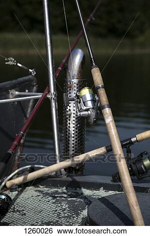 An arrangement of various fishing rods on a lake jetty View Large Photo Image Stock Photograph - An arrangement of various fishing rods on a lake jetty. Fotosearch