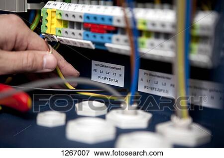 An electrician working on a fuse box, close-up View Large Photo Image Stock Photo - An electrician working on a fuse box, close-up. Fotosearch