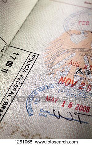 Stock Photography - An open passport with several entrance stamps on the pages. Fotosearch