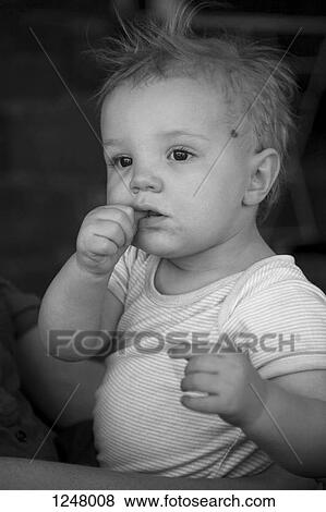 Stock Photo - Baby on Father's lap looking away. Fotosearch