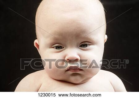 Stock Photography - Baby pulling a funny face. Fotosearch