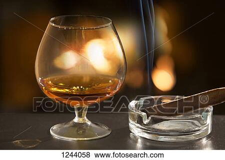 Brandy glass and cigar View Large Photo Image Stock Photo - Brandy glass and cigar. Fotosearch