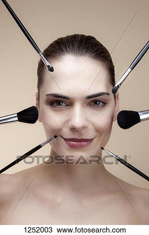 Close-up of a smiling young woman with various make-up brushes around her face View Large Photo Image Stock Image - Close-up of a smiling young woman with various make-up brushes around her face. Fotosearch