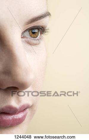 Close-up of beautiful brown eyed woman looking into distance View Large Photo Image Stock Photo - Close-up of beautiful brown eyed woman looking into distance. Fotosearch