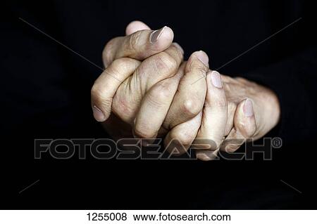 Stock Photo - Close-up of clasped hands. Fotosearch