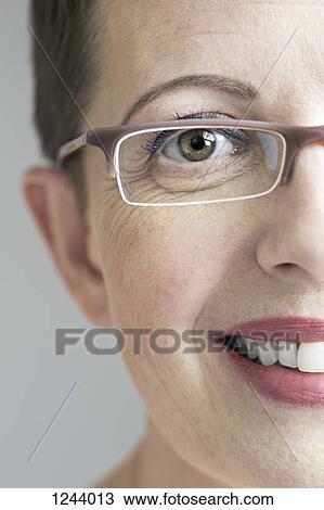 Close up of smiling woman with glasses View Large Photo Image Stock Image - Close up of smiling woman with glasses. Fotosearch