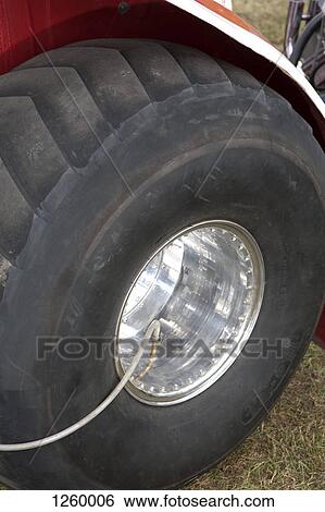 Close-up, tractor tire being inflated by air pump View Large Photo Image Stock Photograph - Close-up, tractor tire being inflated by air pump. Fotosearch