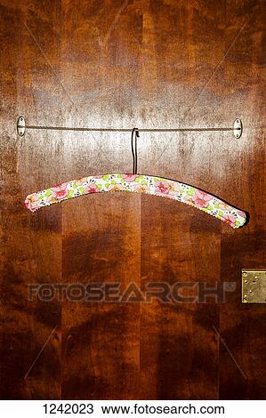 Clothes hanger on wire inside wooden wardrobe View Large Photo Image Stock Image - Clothes hanger on wire inside wooden wardrobe. Fotosearch