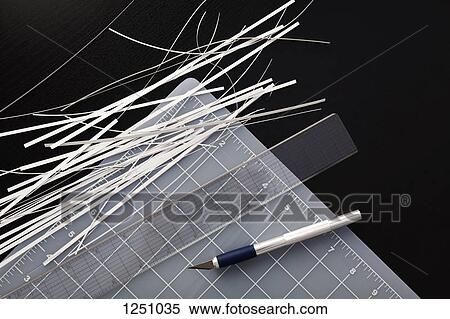 Corner of a cutting mat with shredded paper, ruler and utility knife on black background View Large Photo Image Stock Photography - Corner of a cutting mat with shredded paper, ruler and utility knife on black background. Fotosearch