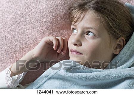 Daydreaming girl under blanket View Large Photo Image Stock Image - Daydreaming girl under blanket. Fotosearch