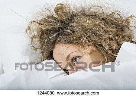 Daydreaming woman in bed under white blanket View Large Photo Image Stock Image - Daydreaming woman in bed under white blanket. Fotosearch