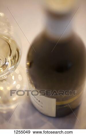 Detail of a bottle of white wine and a wine glass View Large Photo Image Stock Photo - Detail of a bottle of white wine and a wine glass. Fotosearch