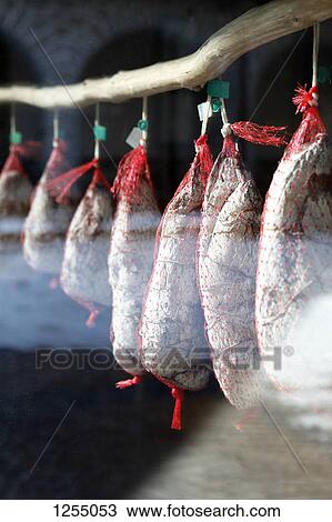 Detail of prosciutto hanging in a shop window View Large Photo Image Stock Image - Detail of prosciutto hanging in a shop window. Fotosearch