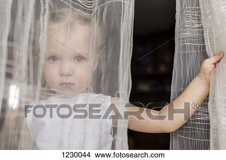 Girl staring behind translucent curtains View Large Photo Image Picture - Girl staring behind translucent curtains. Fotosearch