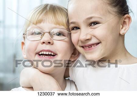 Girl with her arm around her friend View Large Photo Image Stock Photo - Girl with her arm around her friend. Fotosearch