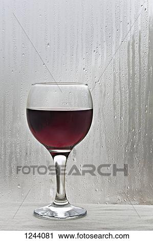 Glass of red wine by rain covered window View Large Photo Image Stock Image - Glass of red wine by rain covered window. Fotosearch