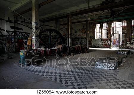 Interior view of an abandoned industrial building with graffiti on the walls View Large Photo Image Picture - Interior view of an abandoned industrial building with graffiti on the walls. Fotosearch