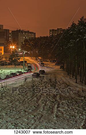 Stock Photo - Long exposure shot of cars moving on a snowy street at night, Voronezh, Russia. Fotosearch