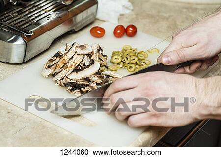 Man chopping vegetables View Large Photo Image Stock Image - Man chopping vegetables. Fotosearch