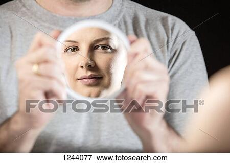 Man holding hand mirror showing reflection of beautiful woman View Large Photo Image Stock Photo - Man holding hand mirror showing reflection of beautiful woman. Fotosearch