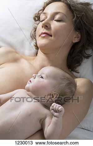 Mother and daughter relaxing on bed View Large Photo Image Stock Image - Mother and daughter relaxing on bed. Fotosearch