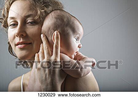 Stock Photo - Mother holding her daughter. Fotosearch