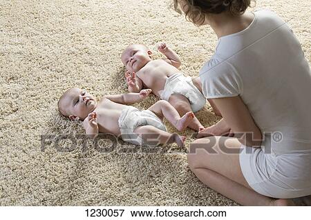 Mother with two babies View Large Photo Image Stock Photo - Mother with two babies. Fotosearch