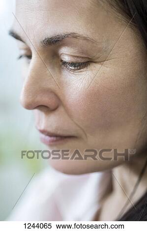 Stock Photography - Pensive woman looking down. Fotosearch