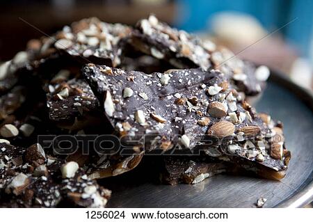 Pieces of homemade chocolate piled in a heap on a tray in a cafe View Large Photo Image Picture - Pieces of homemade chocolate piled in a heap on a tray in a cafe. Fotosearch