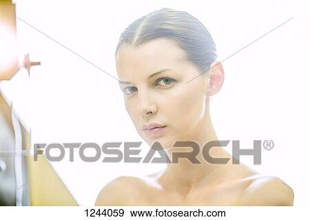 Stock Photo - Portrait of beautiful woman looking at camera. Fotosearch