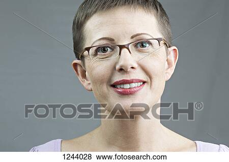 Portrait of smiling woman with glasses View Large Photo Image Stock Photo - Portrait of smiling woman with glasses. Fotosearch