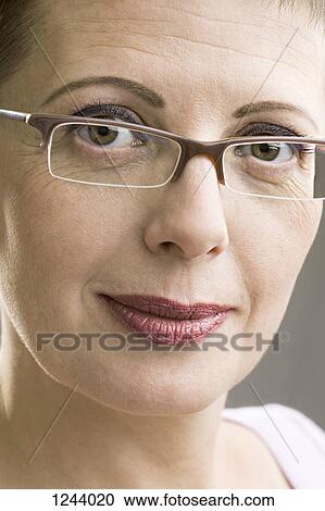 Stock Image - Portrait of woman with glasses. Fotosearch
