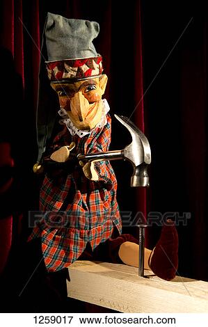 Punch form the puppet show Punch and Judy hammering a nail on stage View Large Photo Image Stock Photo - Punch form the puppet show Punch and Judy hammering a nail on stage. Fotosearch