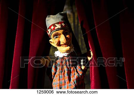 Punch from the classic puppet show Punch and Judy parting the curtains on stage View Large Photo Image Stock Photograph - Punch from the classic puppet show Punch and Judy parting the curtains on stage. Fotosearch
