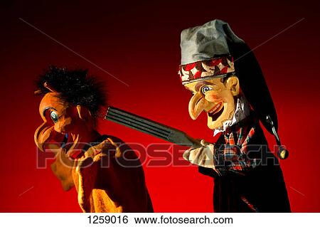 Punch from the classic puppet show Punch and Judy threatens the Devil with a weapon View Large Photo Image Stock Photograph - Punch from the classic puppet show Punch and Judy threatens the Devil with a weapon. Fotosearch