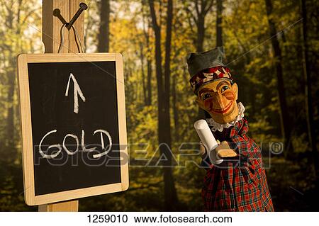 Punch from the Punch and Judy standing next to a board with Gold written on it View Large Photo Image Stock Image - Punch from the Punch and Judy standing next to a board with Gold written on it. Fotosearch