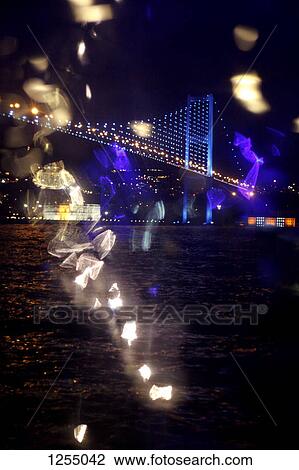 Reflected light and view of an illuminated bridge over water at night View Large Photo Image Stock Image - Reflected light and view of an illuminated bridge over water at night. Fotosearch