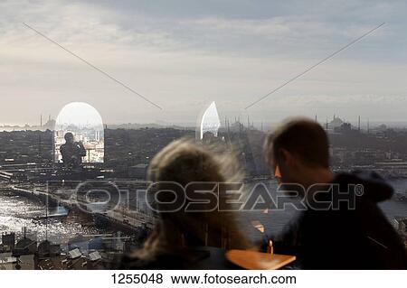 Stock Photo - Reflection in a window of the Galata Tower and the city, Istanbul, Turkey. Fotosearch