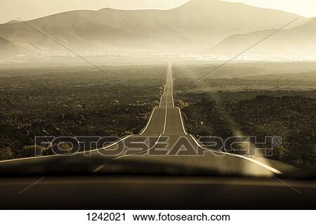 Rolling road leading to mountains in Lanzarote, Canary Islands, Spain View Large Photo Image Stock Image - Rolling road leading to mountains in Lanzarote, Canary Islands, Spain. Fotosearch