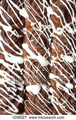 Rows of cinnamon rolls, full frame View Large Photo Image Stock Photo - Rows of cinnamon rolls, full frame. Fotosearch