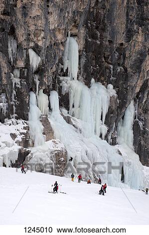 Skiers observe ice climber on rock face at Lagazuoi, South Tyrol, Italy View Large Photo Image Stock Image - Skiers observe ice climber on rock face at Lagazuoi, South Tyrol, Italy. Fotosearch