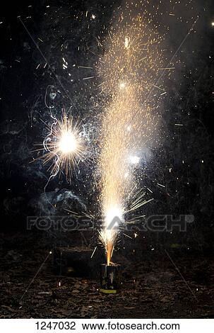 Sparks and smoke coming out of a firework exploding on a sidewalk View Large Photo Image Stock Image - Sparks and smoke coming out of a firework exploding on a sidewalk. Fotosearch