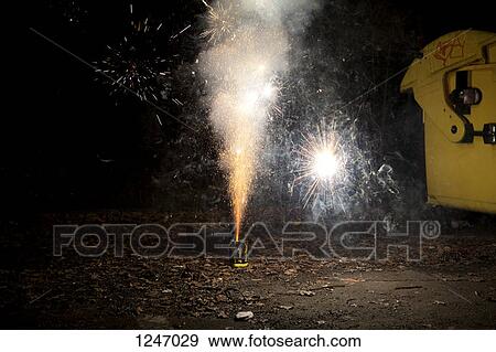 Sparks and smoke coming out of a firework exploding on a sidewalk View Large Photo Image Stock Photo - Sparks and smoke coming out of a firework exploding on a sidewalk. Fotosearch