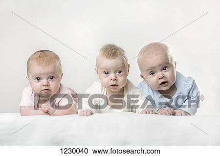 Stock Image - Three babies making funny faces. Fotosearch
